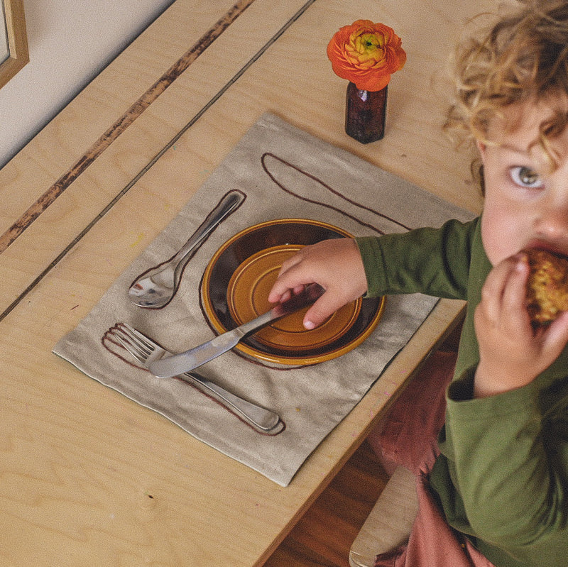 montessori placemat on table with child