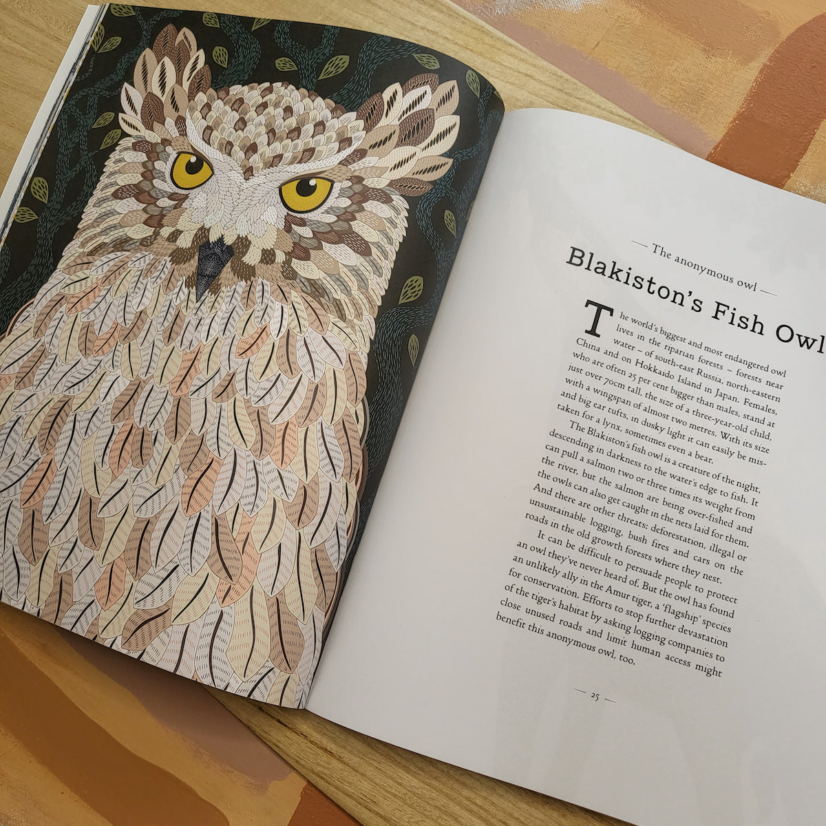 Image of a children's book about A Wild Childs Guide to Endangered Animals. The page is about the Blakiston's Fish Owl.