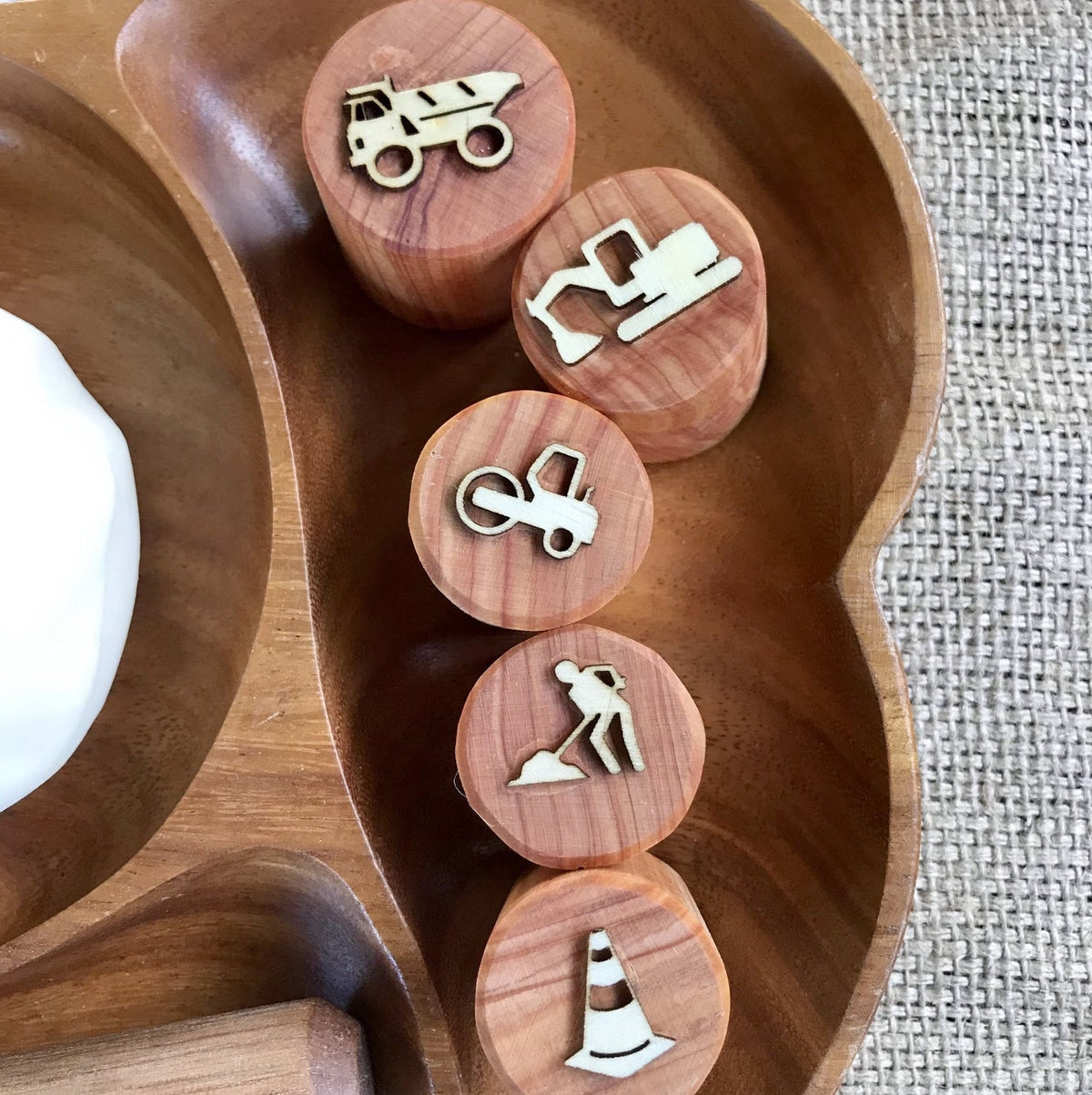 image of construction themed play dough stamps in a wooden bowl